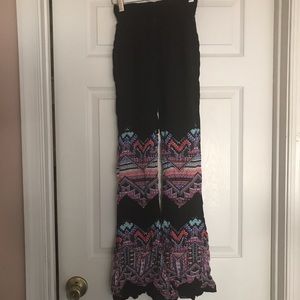 Black flare pants with vibrant Aztec print